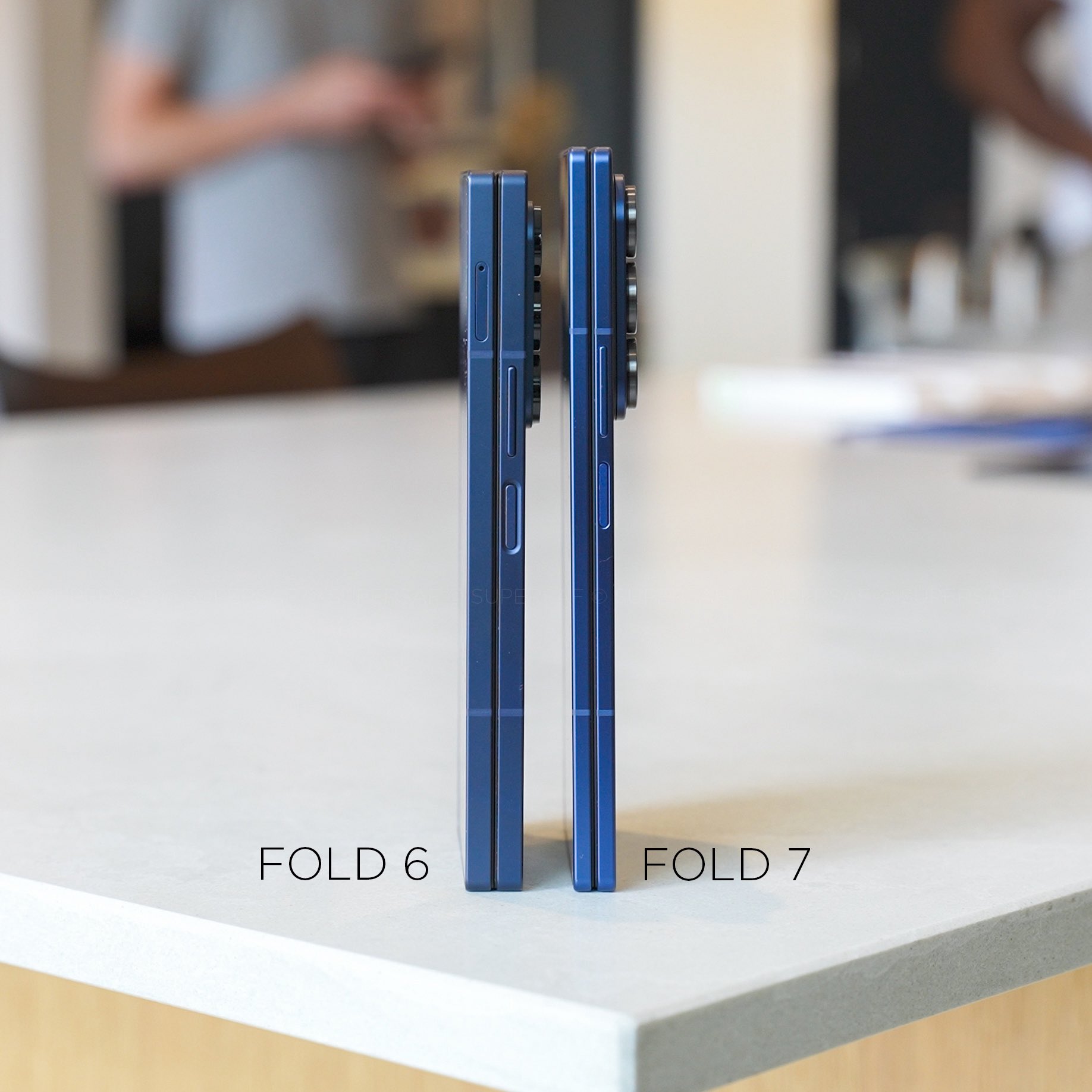 Side-by-side comparison of the Samsung Galaxy Z Fold 6 and Z Fold 7 highlighting the reduced thickness and refined design of the Fold 7.